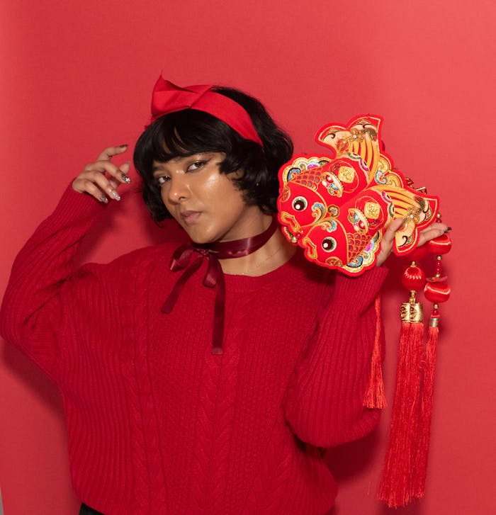 Portrait of a woman in red with Chinese New Year decorations, Chicago.